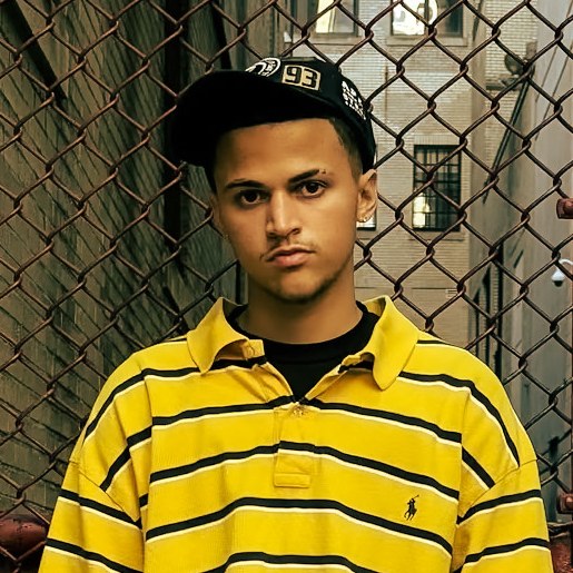 Portrait of the photographer behind PBMediia in a yellow striped polo and black cap